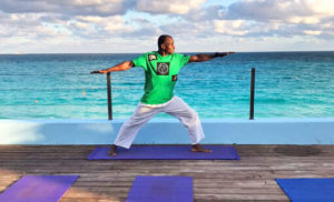 An instructor leading a yoga session at a Nassau resort for people to join after watching the Junkanoo parade.