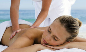 A woman getting a massage at a Nassau resort after a romantic picnic date.