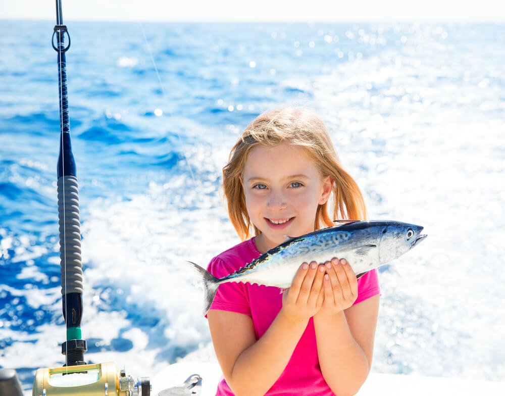 A little girl fishing, one of the top results when searching "water activities near me" in Nassau.