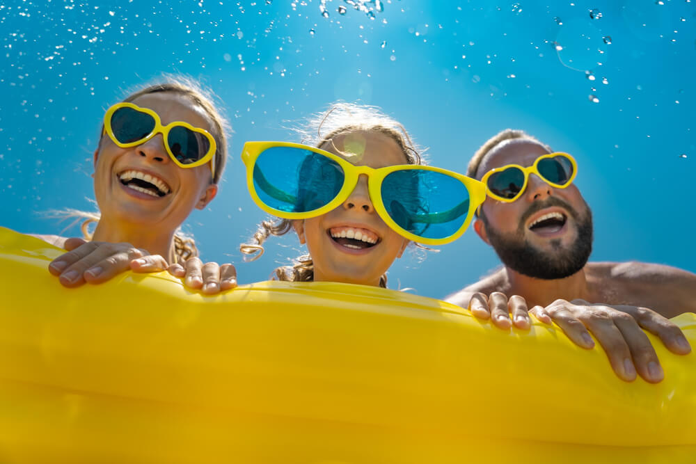 A family floating on an inflatable at a waterpark, one of the best things to do on Paradise Island.