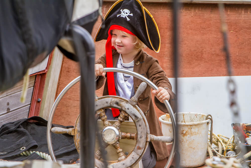 A little kid dressed up for a Nassau pirates tour.