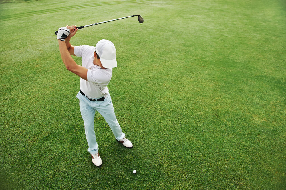 A man at one of the best golf courses in Nassau, Bahamas.